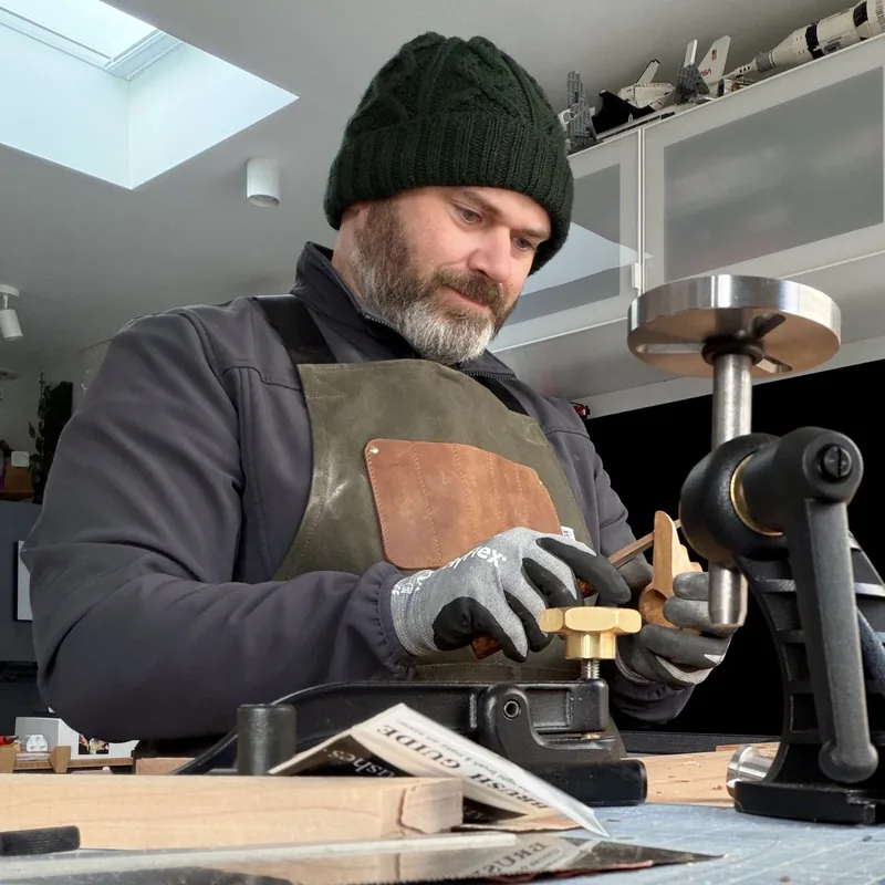 Barry Carroll carving a wooden spoon in his workshop